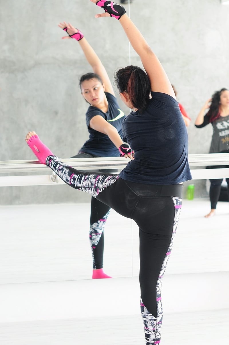 Woman practicing barre exercises